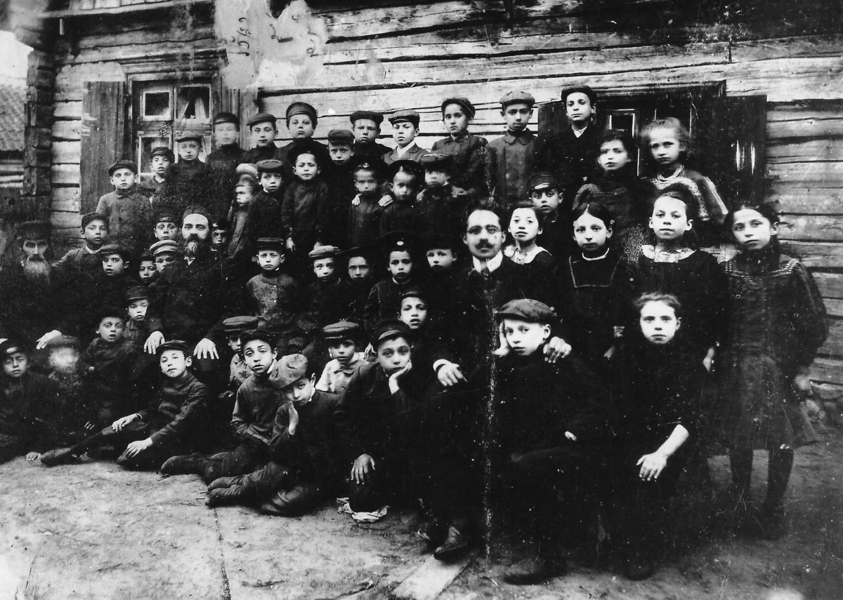 Cheder group, Linkuva (circa 1906). My father at centre with badge on cap. His father, Rev Hirsche Leib Behr, bearded, second teacher on left.