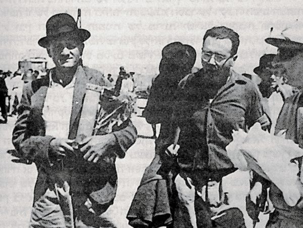 Returnees to Israel bringing Sefer Torah from Gilgil detention camp, July 1948 (source: https://blog.nli.org.il/en/hoi-exiles/)